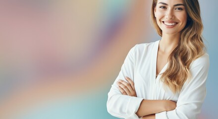 Woman smiling with arms crossed against pastel blurred background and copyspace