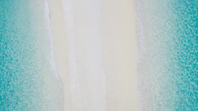 Advancing surf washing central sand strip at coast, showing wet bands and turquoise sea, wind