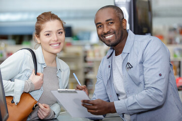 Fototapeta premium portrait of happy staff and customer looking at camera