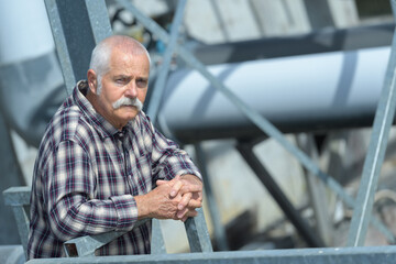 Fototapeta premium mature man standing on waste water treatment unit