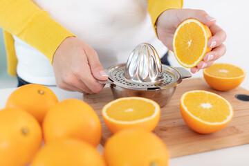 closeup on woman making orange juice