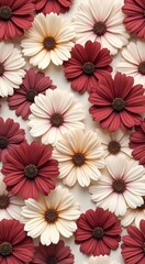 Many different colored flowers arranged on a white surface