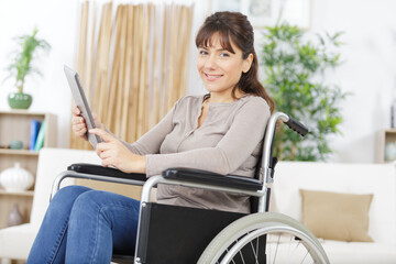 woman invalid girl on wheelchair using tablet
