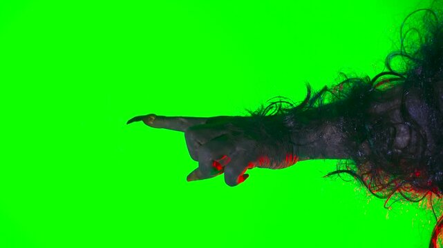 a scary hand with claws, a wolf's paw, a werewolf's paw, and a monster's paw pointing forward on a green background