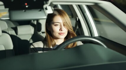 Sunlight hitting woman in light jacket raising head, opening eyes, gripping wheel in cabin to focus