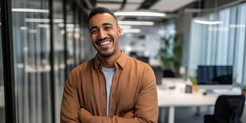Confident young African American businessman smiling in a modern office environment