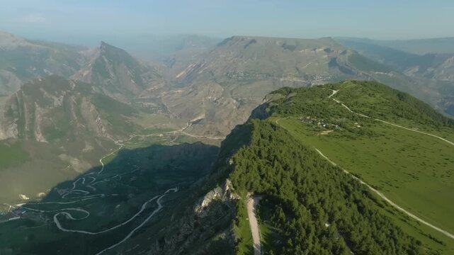Aerial panoramic view of the famous winding SH20 highway, known for its hairpin turns above the Cem River gorge in the Leqet e Hotit region of Northern Albania.