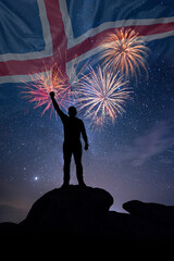 Fototapeta premium Man against background of a fireworks and national flag of Iceland