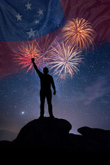 Man against background of a fireworks and national flag of Samoa