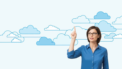 Businesswoman Points Towards Cloud Computing Solution In The Sky Over Blue Backdrop