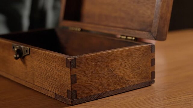 Vintage wooden box opening and closing slowly on a wooden table with close-ups