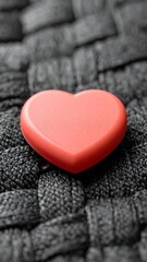 Fototapeta premium Close Up of Red Heart Shape on Woven Dark Gray Background Surface
