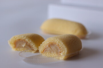 Japanese banana cream sponge cake with soft texture, photographed close up on a clean white background © Trending Now