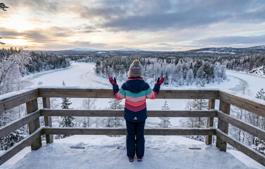 Woman standing on a snowy ski slope at ski resort