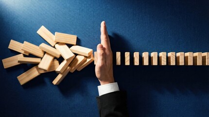 Hand Stopping Dominoes in Motion Symbolizing Control Over Chaos and Preventing Disruption in Business Setting