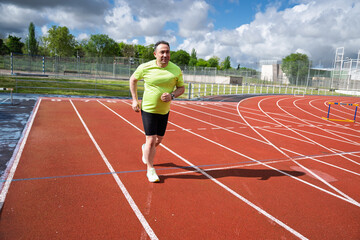 Fototapeta premium Man jogging on running track for fitness training
