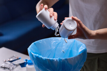 Responsible medication disposal in residential living space, An individual safely discards expired...