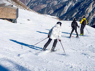 Skier is skiing down a snowy slope