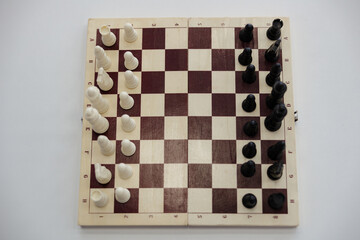 Chessboard ready for a strategic battle between white and black pieces in a silent arena