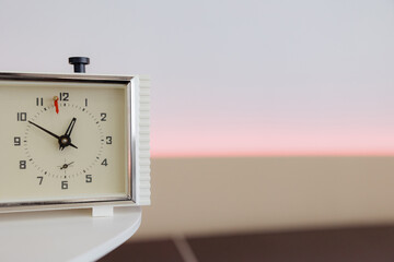 Classic clock set against a serene background in a minimalistic interior space