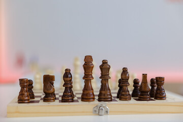 Elegant wooden chess pieces poised for a strategic duel on a timeless board