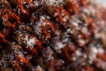 Snowflake. Macro.  A small snowflake on a knitted scarf.