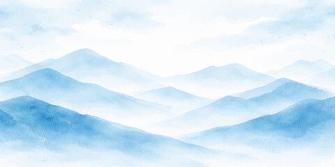 Fototapeta premium A beautiful aerial view of white clouds in the blue sky over a snowy mountain landscape with misty hills at sunset