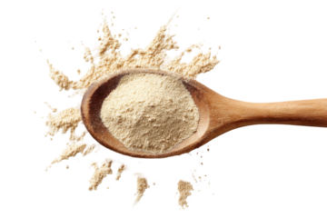 Wooden spoon with powder splashing isolated on transparent background. Wooden spoon with maca powder spilling onto surface isolated on white background.