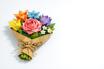 Colorful origami flower bouquet arranged in paper wrapping with ribbon  