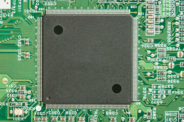 A processor on a green printed circuit board.
