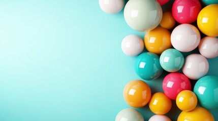 A vibrant collection of glossy balls in various sizes and colors spills onto a bright turquoise background, creating a playful and cheerful atmosphere that inspires joy.