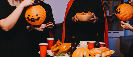 Friends enjoying a Halloween party at a bar making a toast