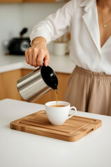 Woman serving a cup of coffee in the kitchen
