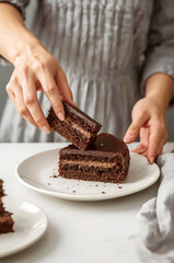 Woman holding a slice of chocolate cake