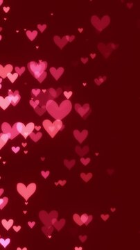 Romantic red and pink heart particles slowly floating from the left side on red background. Soft glowing hearts celebrating love, affection, passion, or for loving Valentine's day backgrounds.