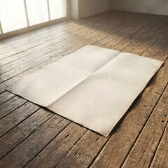 Blank folded paper sheet on rustic wooden floor in sunlit room.