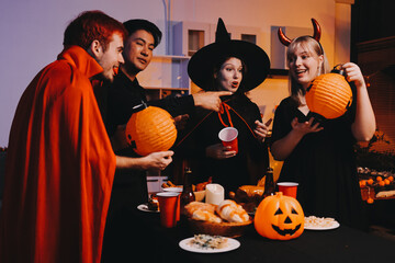 Friends enjoying a Halloween party at a bar making a toast