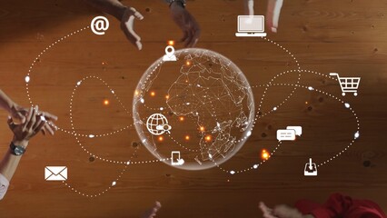 Hands surround a globe displaying digital icons that symbolize global communication and technology. This image represents teamwork and innovation in a connected world. Raster