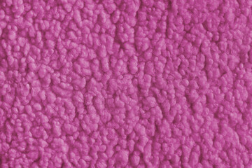 Vibrant pink color fabric texture of soft faux fur cloth with fluffy surface, abstract background. Close up, macro of shaggy fabric texture, upholstery material, textile backdrop