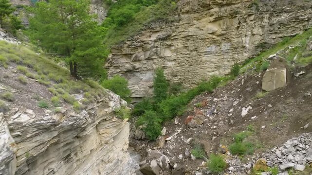 aerial view captures the Kara-Koisu River as it winds through a rugged, deep canyon in the mountainous region of Dagestan, Russia. The footage showcases the stunning natural beauty of the North Caucas