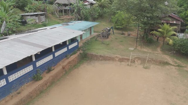 Aerial drone view of Embera Drua indigenous village located along the Chagres River in Colon, Panama. This cinematic scene showcases traditional huts, river landscape, and surrounding tropical rainfor
