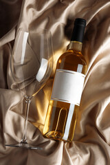 White Wine Bottle and Glass on Satin Background. Elegant Celebration Still Life