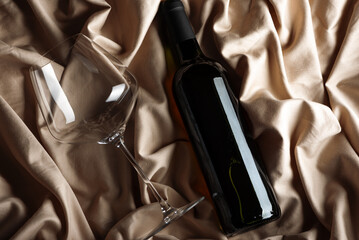 RedWine Bottle and Glass on Satin Background. Elegant Celebration Still Life
