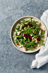 Healthy Beetroot Salad with feta cheese, walnuts and honey-lemon dressing. Copy space
