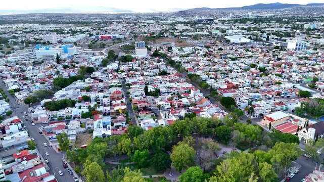Church "Parroquia Sagrada Familia" in Queretaro, located among parks in an urban area aerial view