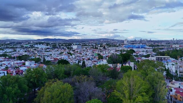 Church "Parroquia Sagrada Familia" in Queretaro, located among parks in an urban area aerial view