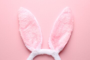 Cute headband with bunny ears on pink background, top view. Happy Easter