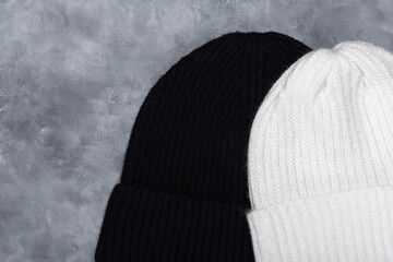 White and black woolen hats. Top view.