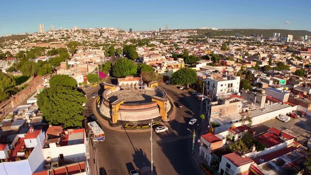 Church "Templo de la Cruz" in Queretaro, located among parks in an urban area aerial view