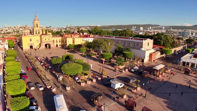 Church "Templo de la Cruz" in Queretaro, located among parks in an urban area aerial view